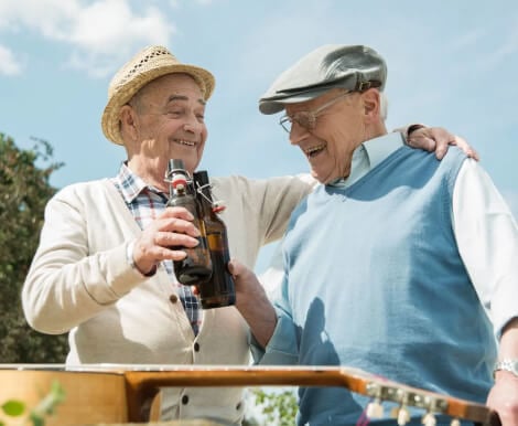 Two Male Residents Enjoying Outdoor Activities at Independent Living Facility Two Male Residents Enjoying Outdoor Activities at Independent Living Facility