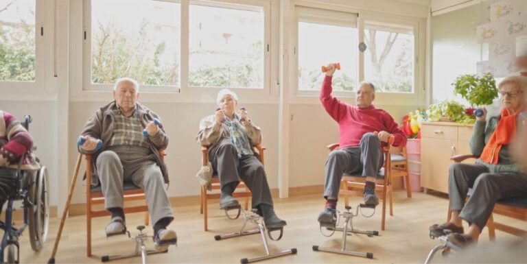 Elderly Residents Exercising With Small Weights In Group At Assisted Living Facility